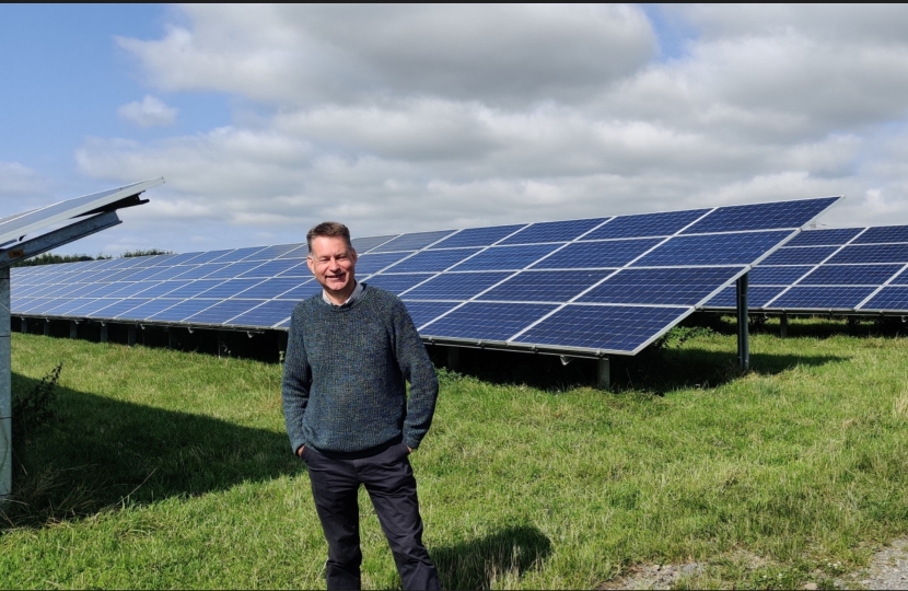 Murdo Fraser MSP stands infront of a solar farm